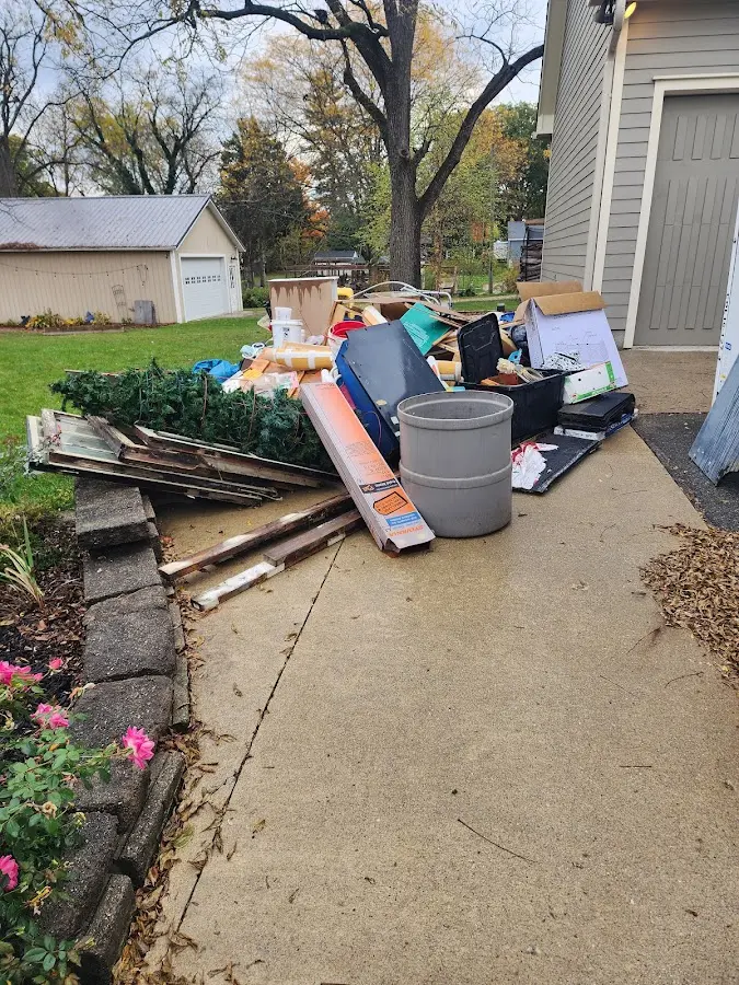 Dumpster being loaded with debris for Roofing Dumpster Rental in New Haven